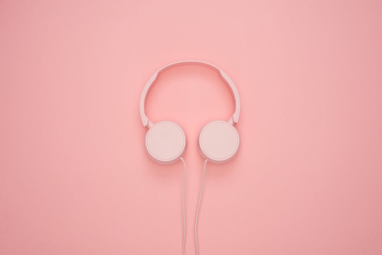 Aesthetic pink headphones on a pastel background, perfect for a modern and stylish look.