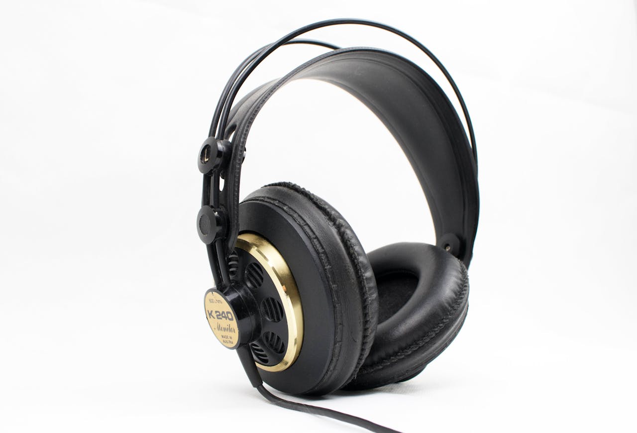 High-quality black and gold studio headphones with thick padding on a white background, ideal for music professionals.